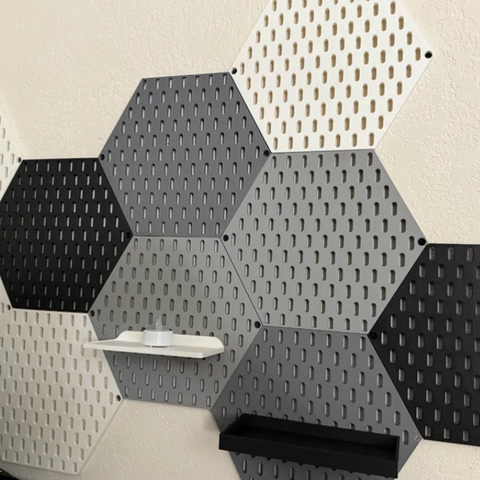 3D-printed hexagonal pegboard tiles in multiple colors