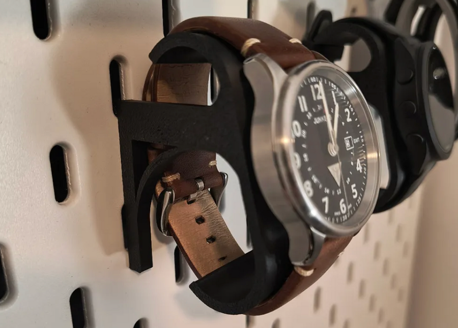 3D-printed pegboard watch holder cradling a watch