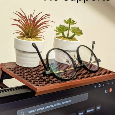 3D-printed monitor-top shelf riser with plants and glasses