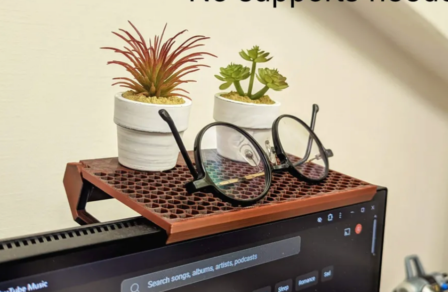 3D-printed monitor-top shelf riser with plants and glasses