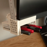 Under-monitor storage basket holding tools